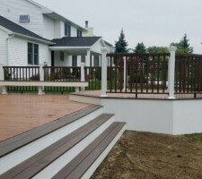 Large brown and white custom shaped wooden deck